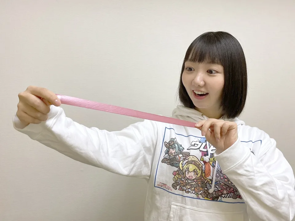 Stretching a UREHERO-painted strip with both hands